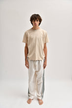 Load image into Gallery viewer, Front image of cream and khaki cotton trousers featuring a wide-leg, relaxed fit with a linen-style drape.
