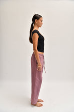 Load image into Gallery viewer, Side image of striped cotton trousers with a relaxed, wide-leg fit, designed to mimic the breezy look of linen.
