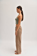 Load image into Gallery viewer, Side image of striped cotton trousers with a relaxed, wide-leg fit, designed to mimic the breezy look of linen.
