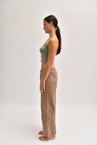 Side image of striped cotton trousers with a relaxed, wide-leg fit, designed to mimic the breezy look of linen.
