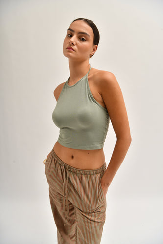 Front image of striped cotton trousers with a relaxed, wide-leg fit, designed to mimic the breezy look of linen.