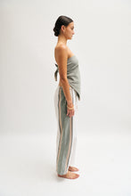 Load image into Gallery viewer, Side image of cream and khaki cotton trousers featuring a wide-leg, relaxed fit with a linen-style drape.
